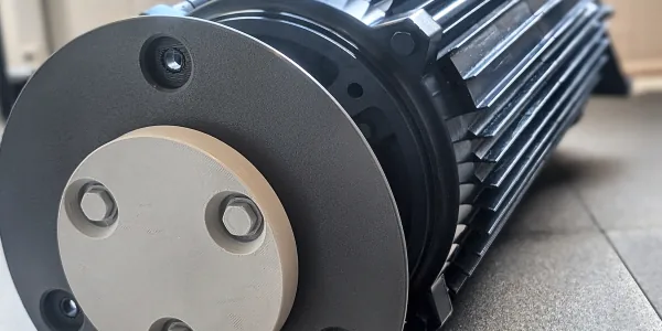 Black 3D printed replica of an industrial motor with a grey mounting flange