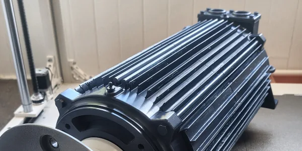 Full-size 3D printed replica of an industrial electric motor on the large-format printer bed