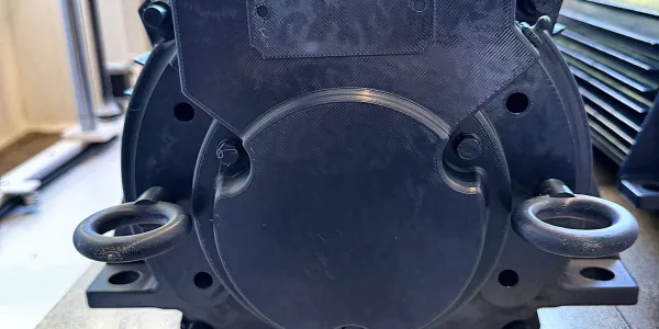 Black 3D printed replica motor end cover with lifting eyes
