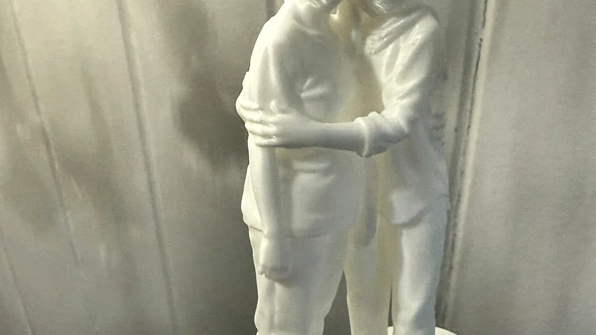 White 3D printed figurine of a couple on a heart-shaped base